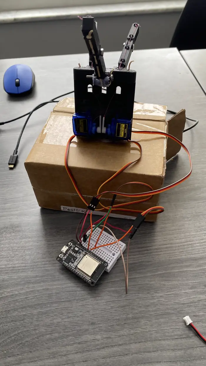 Assembled EMG-controlled robotic hand with EMG sensor and ESP32 boards