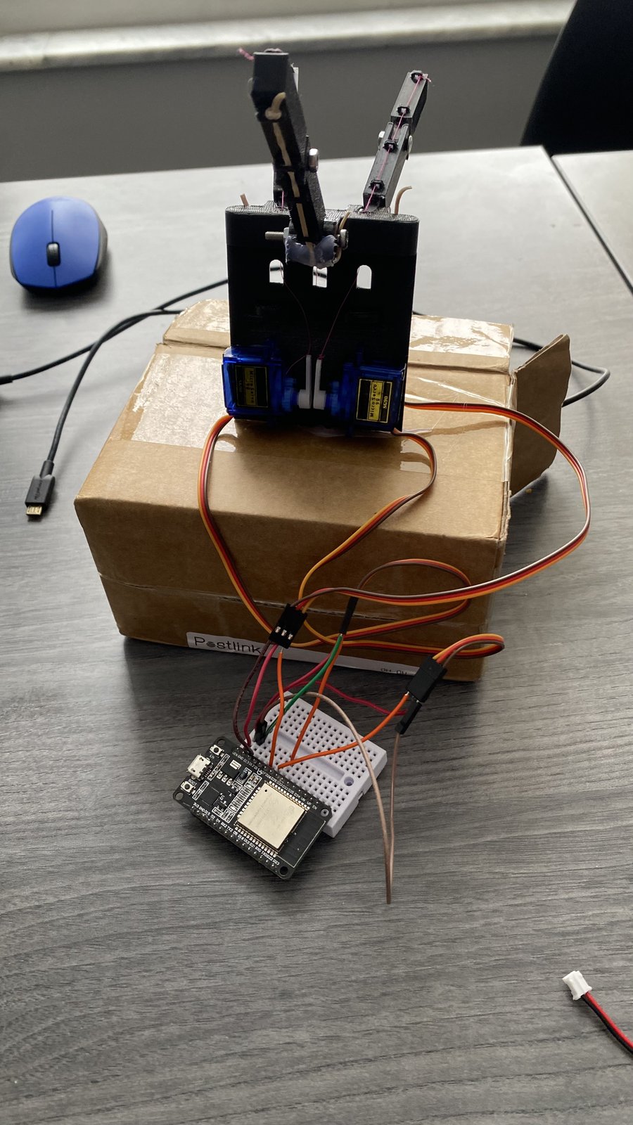 Assembled EMG-controlled robotic hand with EMG sensor and ESP32 boards