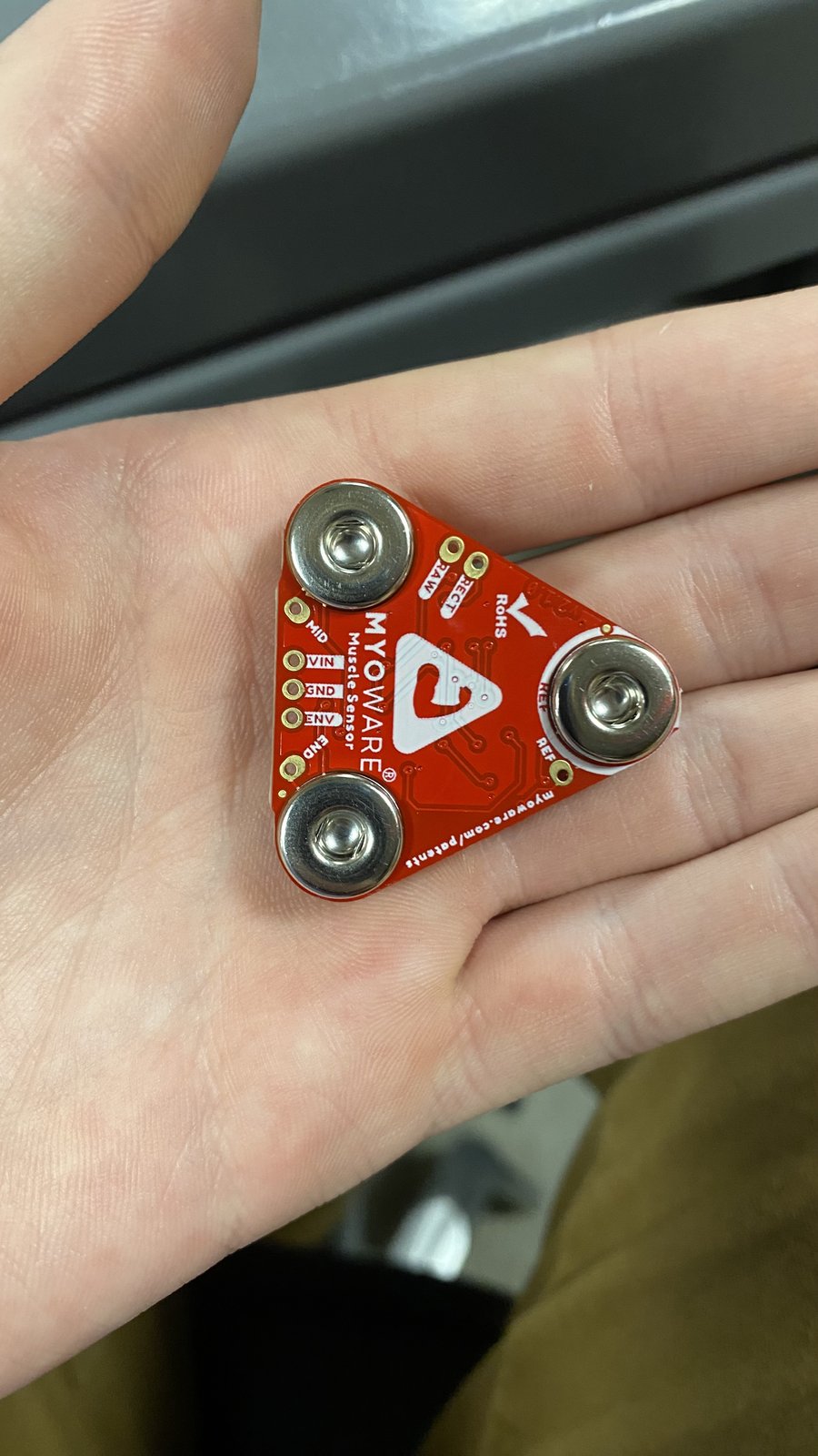 MyoWare EMG muscle sensor held in a hand